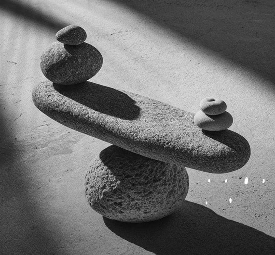 Stones balanced on a rock in low light