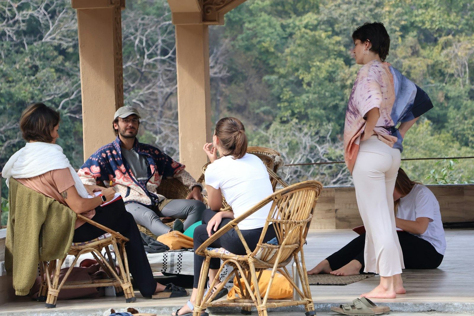 A small group relaxing together on a shaded veranda